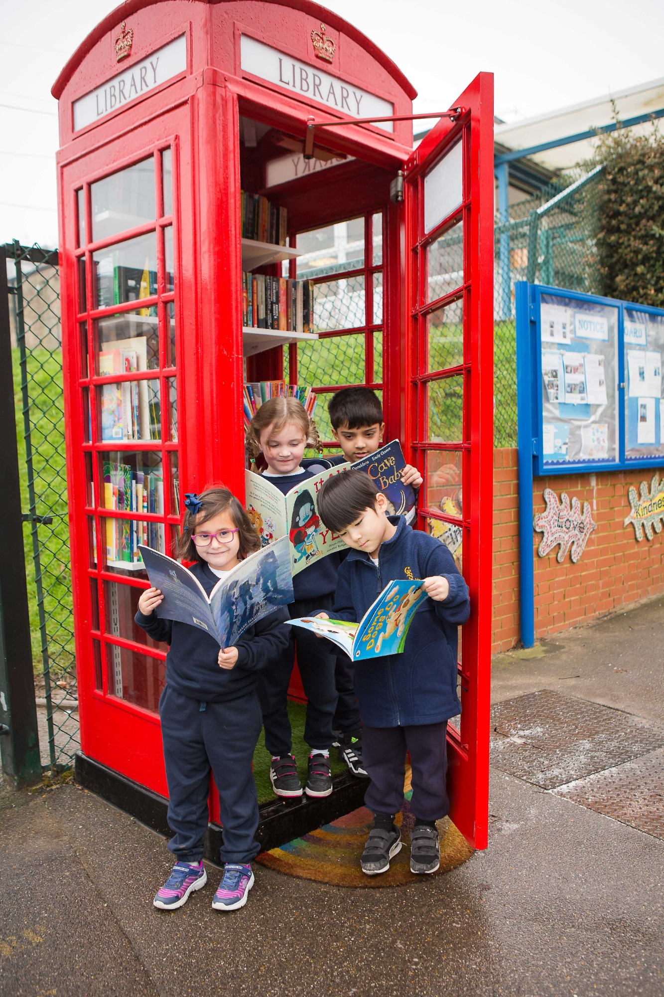 Children using the telephone box lending library